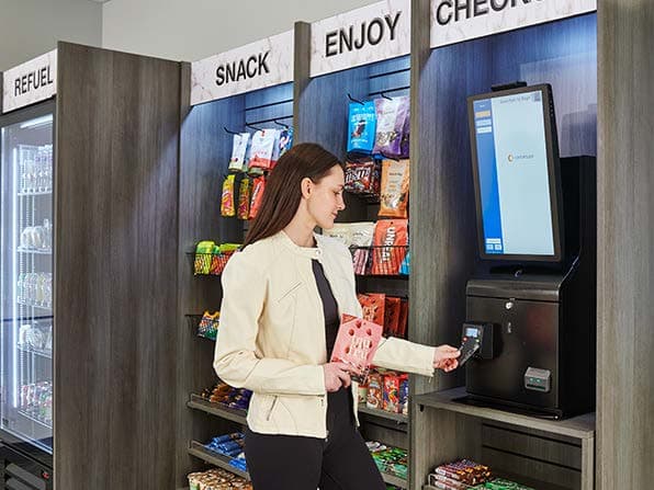 A customer using self-checkout in a micro market